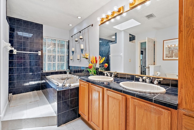 9494 SE Cove Point St, Jupiter, FL 33469 - bathroom featuring a jetted tub, tile patterned flooring, double vanity, and a skylight