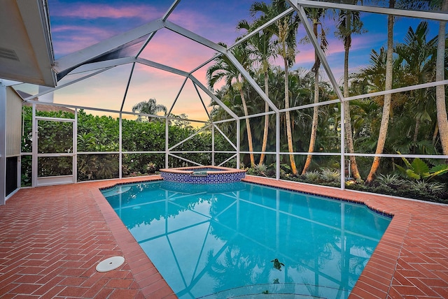 9494 SE Cove Point St, Jupiter, FL 33469 - pool at dusk featuring glass enclosure and a pool with connected hot tub