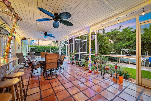 9494 SE Cove Point St, Jupiter, FL 33469 - patio terrace at dusk featuring a patio area, outdoor dining space, a lanai, and ceiling fan