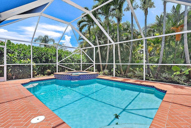 9494 SE Cove Point St, Jupiter, FL 33469 - view of swimming pool with glass enclosure, a pool with connected hot tub, and a patio