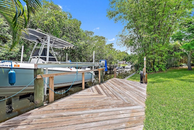 9494 SE Cove Point St, Jupiter, FL 33469 - dock with a lawn, a water view, boat lift, and view of scattered trees