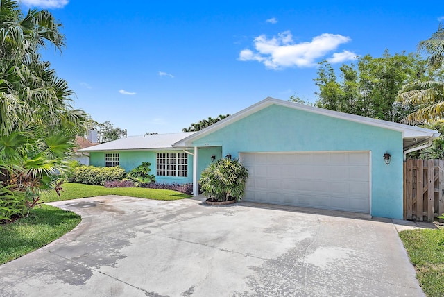 9494 SE Cove Point St, Jupiter, FL 33469 - ranch-style home featuring stucco siding, driveway, and an attached garage