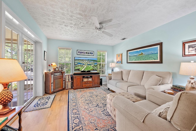 9494 SE Cove Point St, Jupiter, FL 33469 - living area with a textured ceiling, light wood-style floors, and ceiling fan