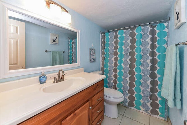 2615 NE 3rd Ct Unit 217, Boynton Beach, FL 33435 - full bathroom featuring vanity, toilet, and tile patterned flooring