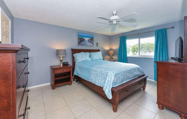 2615 NE 3rd Ct Unit 217, Boynton Beach, FL 33435 - bedroom featuring a textured ceiling, baseboards, ceiling fan, and light tile patterned flooring