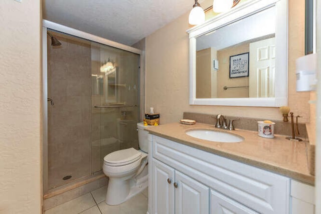 2615 NE 3rd Ct Unit 217, Boynton Beach, FL 33435 - bathroom featuring tile patterned flooring, vanity, toilet, a stall shower, and a textured ceiling