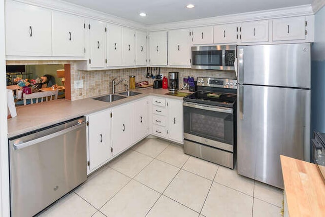 2615 NE 3rd Ct Unit 217, Boynton Beach, FL 33435 - kitchen with stainless steel appliances, a sink, light countertops, white cabinetry, and recessed lighting