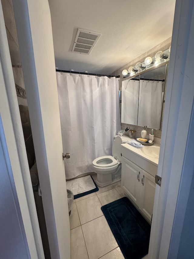 203 S Windsor I Unit 203, West Palm Beach, FL 33417 - bathroom featuring vanity, toilet, tile patterned flooring, and a shower with shower curtain