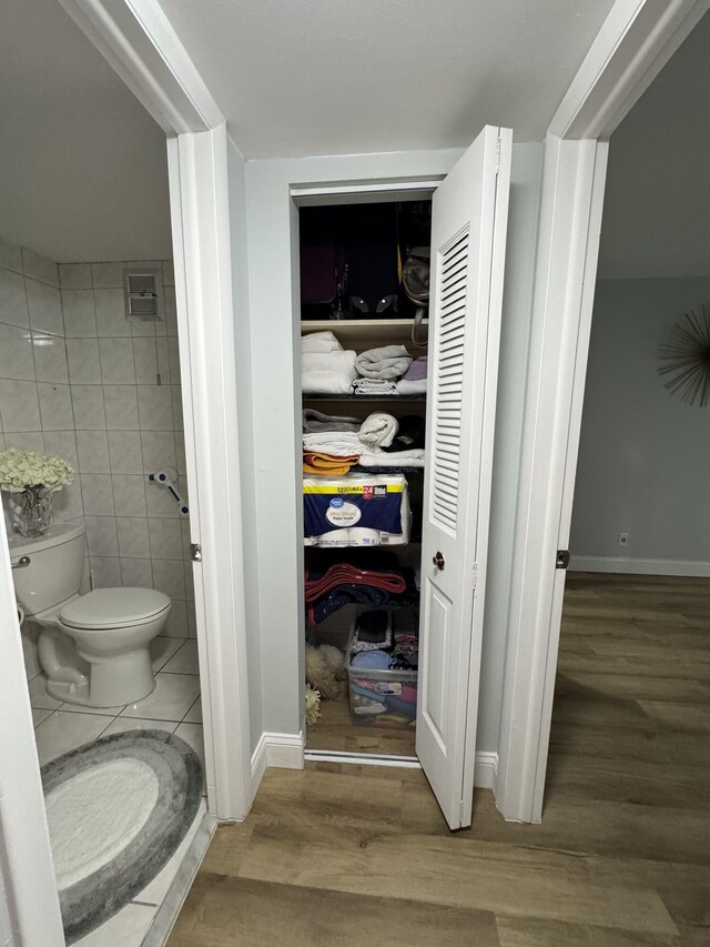 203 S Windsor I Unit 203, West Palm Beach, FL 33417 - bathroom with tile walls, wood finished floors, toilet, and a closet
