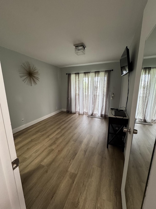 203 S Windsor I Unit 203, West Palm Beach, FL 33417 - unfurnished living room with wood finished floors and baseboards