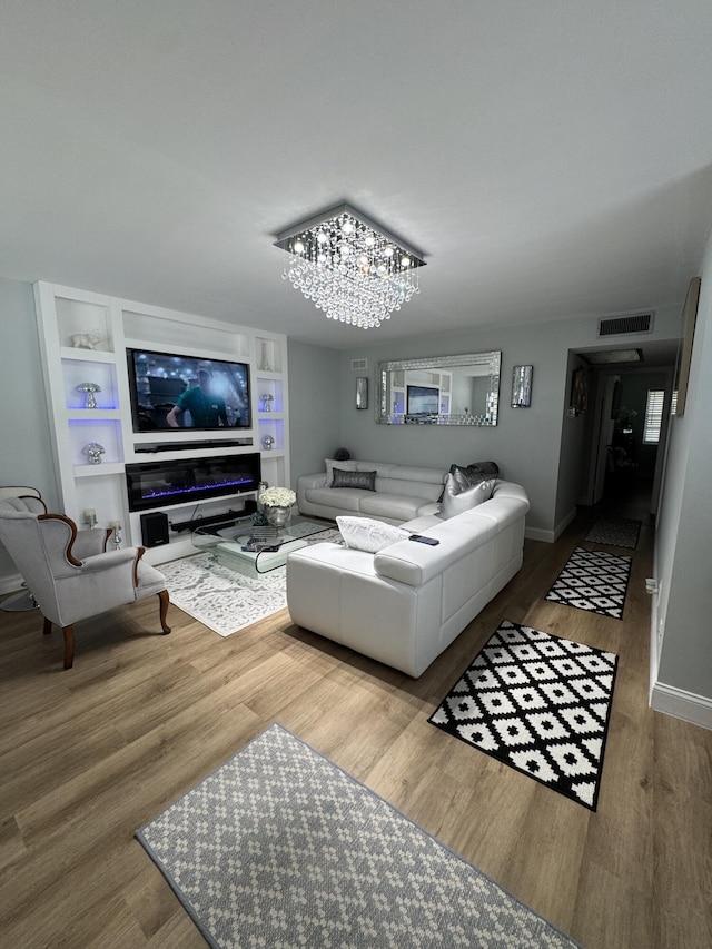 203 S Windsor I Unit 203, West Palm Beach, FL 33417 - living room with wood finished floors, baseboards, a chandelier, and built in features