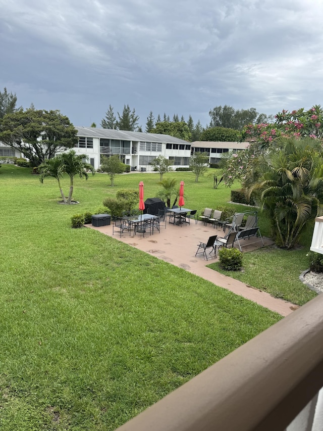 203 S Windsor I Unit 203, West Palm Beach, FL 33417 - view of home's community featuring a patio and a lawn