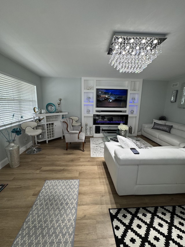 203 S Windsor I Unit 203, West Palm Beach, FL 33417 - living area with light wood finished floors and a chandelier