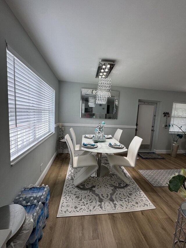 203 S Windsor I Unit 203, West Palm Beach, FL 33417 - dining room with a chandelier, baseboards, and wood finished floors