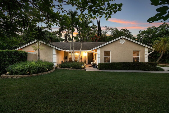 16243 E Calder Dr, Loxahatchee, FL 33470 - view of front of property with stucco siding and a front lawn