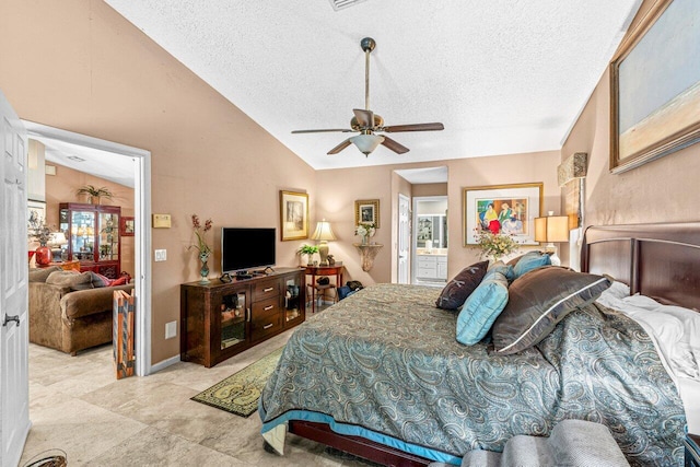 16243 E Calder Dr, Loxahatchee, FL 33470 - bedroom featuring a textured ceiling, vaulted ceiling, connected bathroom, and a ceiling fan