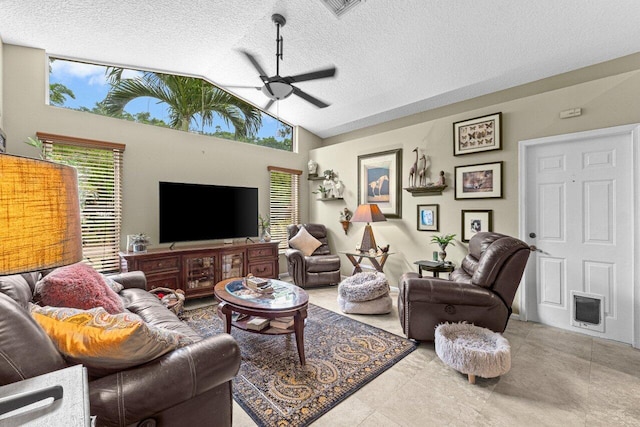 16243 E Calder Dr, Loxahatchee, FL 33470 - living area with ceiling fan, vaulted ceiling, healthy amount of natural light, and a textured ceiling