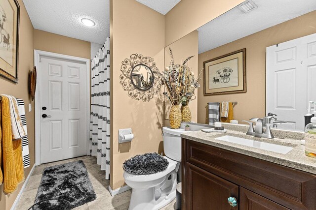 16243 E Calder Dr, Loxahatchee, FL 33470 - full bath featuring a textured ceiling, vanity, toilet, a shower with shower curtain, and baseboards