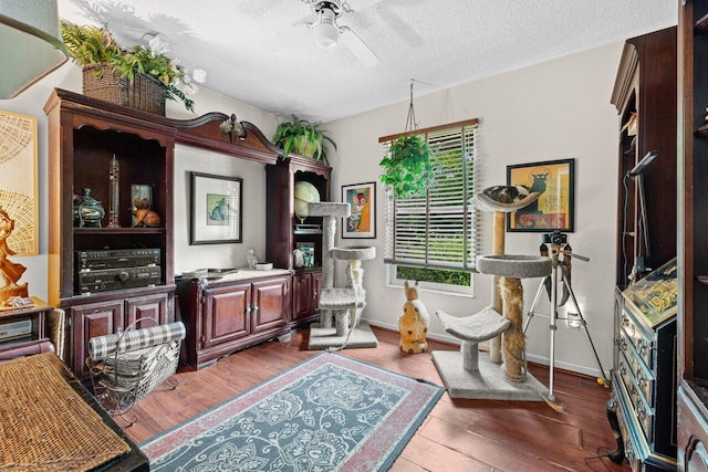 16243 E Calder Dr, Loxahatchee, FL 33470 - office featuring a ceiling fan, a textured ceiling, wood finished floors, and baseboards