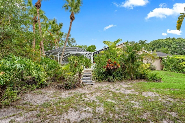 16243 E Calder Dr, Loxahatchee, FL 33470 - view of green lawn with a lanai