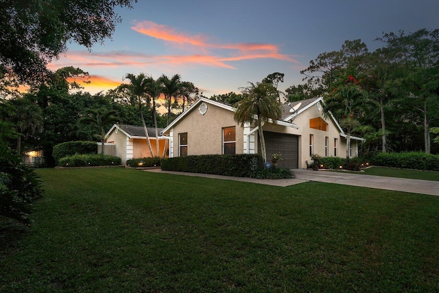 16243 E Calder Dr, Loxahatchee, FL 33470 - ranch-style home featuring stucco siding, a garage, driveway, and a front yard