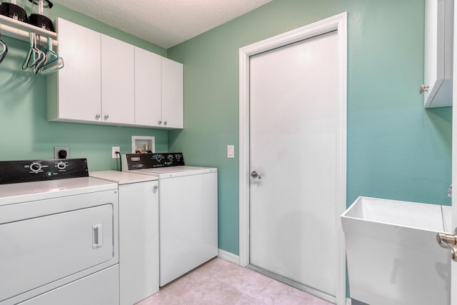 169 Stony Point Dr, Sebastian, FL 32958 - laundry area with cabinet space, independent washer and dryer, a textured ceiling, and light tile patterned flooring