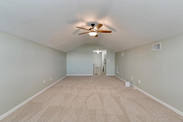 169 Stony Point Dr, Sebastian, FL 32958 - additional living space featuring a textured ceiling, light carpet, a ceiling fan, lofted ceiling, and baseboards