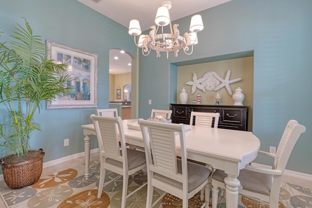 169 Stony Point Dr, Sebastian, FL 32958 - dining room with a chandelier, arched walkways, and baseboards