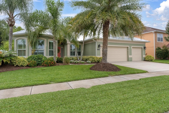 169 Stony Point Dr, Sebastian, FL 32958 - view of front of property with stucco siding, driveway, a garage, and a front yard