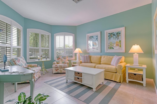 169 Stony Point Dr, Sebastian, FL 32958 - living area with healthy amount of natural light, light tile patterned floors, and baseboards