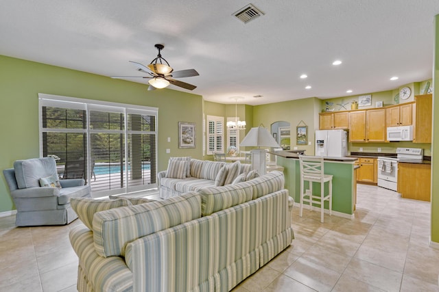 169 Stony Point Dr, Sebastian, FL 32958 - living area featuring a chandelier, recessed lighting, ceiling fan, light tile patterned floors, and baseboards