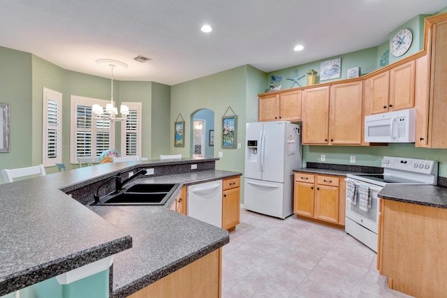 169 Stony Point Dr, Sebastian, FL 32958 - kitchen with white appliances, a sink, a chandelier, dark countertops, and a large island
