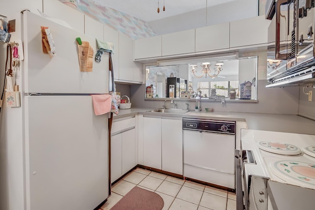 7610 Tahiti Ln Unit 201, Lake Worth, FL 33467 - kitchen featuring white appliances, white cabinetry, light countertops, and light tile patterned floors