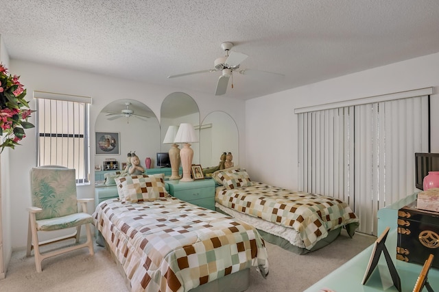 7610 Tahiti Ln Unit 201, Lake Worth, FL 33467 - bedroom with light colored carpet, a textured ceiling, and ceiling fan