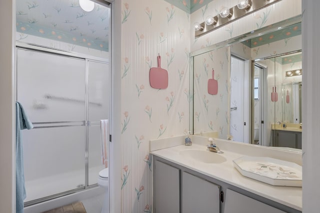7610 Tahiti Ln Unit 201, Lake Worth, FL 33467 - bathroom featuring wallpapered walls, vanity, and a stall shower