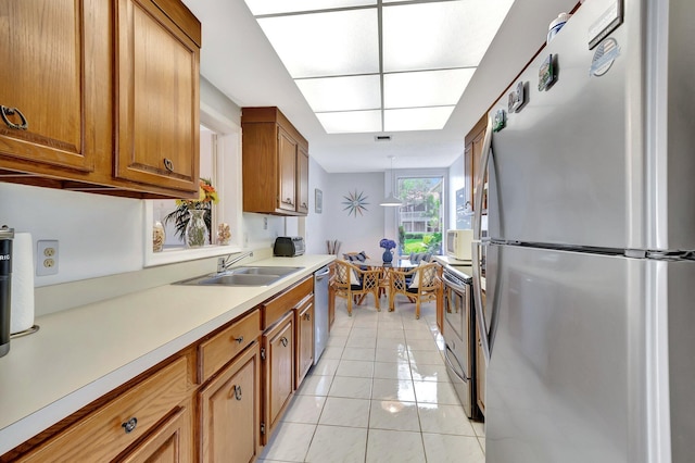 19819 Boca W Dr Unit 4033, Boca Raton, FL 33434 - kitchen with stainless steel appliances, brown cabinets, light countertops, a sink, and light tile patterned floors