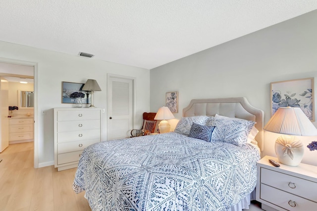 19819 Boca W Dr Unit 4033, Boca Raton, FL 33434 - bedroom featuring light wood-type flooring and a textured ceiling