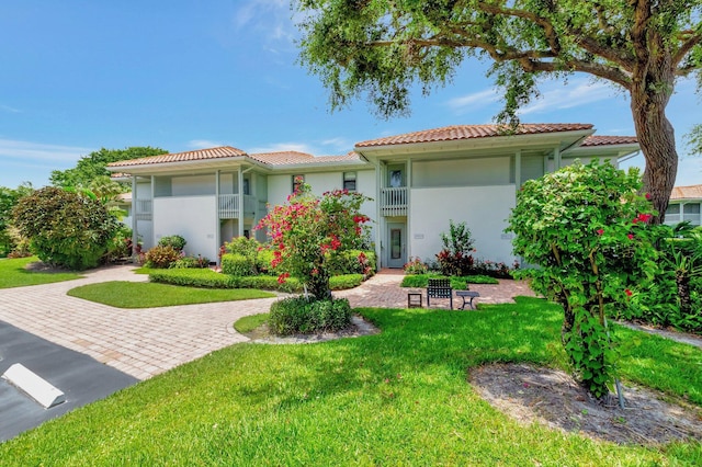 19819 Boca W Dr Unit 4033, Boca Raton, FL 33434 - mediterranean / spanish home featuring a tile roof, stucco siding, and a front lawn