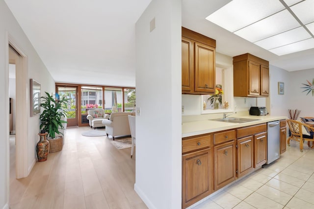 19819 Boca W Dr Unit 4033, Boca Raton, FL 33434 - kitchen featuring dishwasher, a sink, light countertops, and brown cabinetry