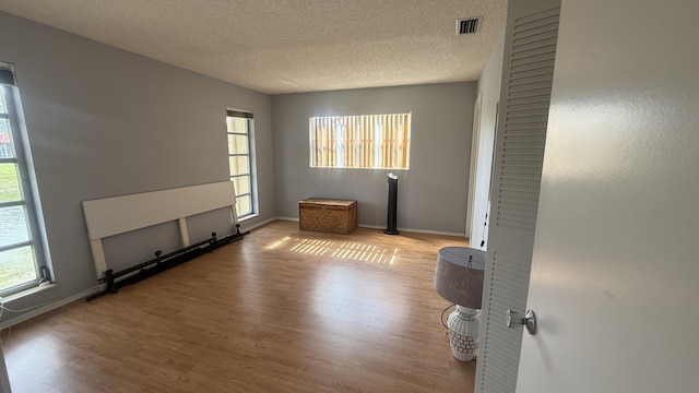 425 Lake Helen Dr, West Palm Beach, FL 33411 - unfurnished room with wood finished floors, a textured ceiling, and baseboards