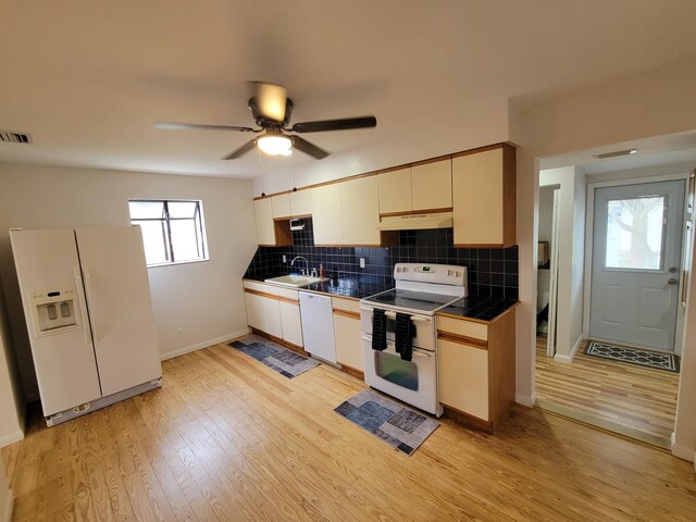 510 N 5th St, Lantana, FL 33462 - kitchen with white appliances, a sink, under cabinet range hood, tile countertops, and baseboards