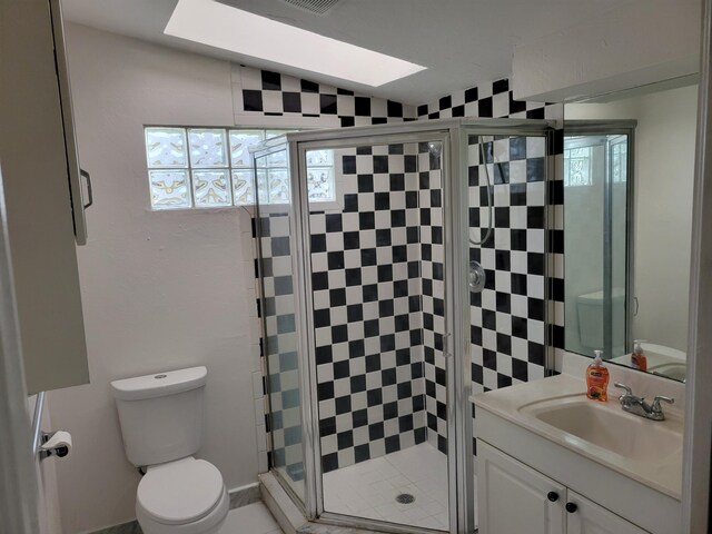 510 N 5th St, Lantana, FL 33462 - bathroom featuring toilet, a stall shower, vanity, and a skylight
