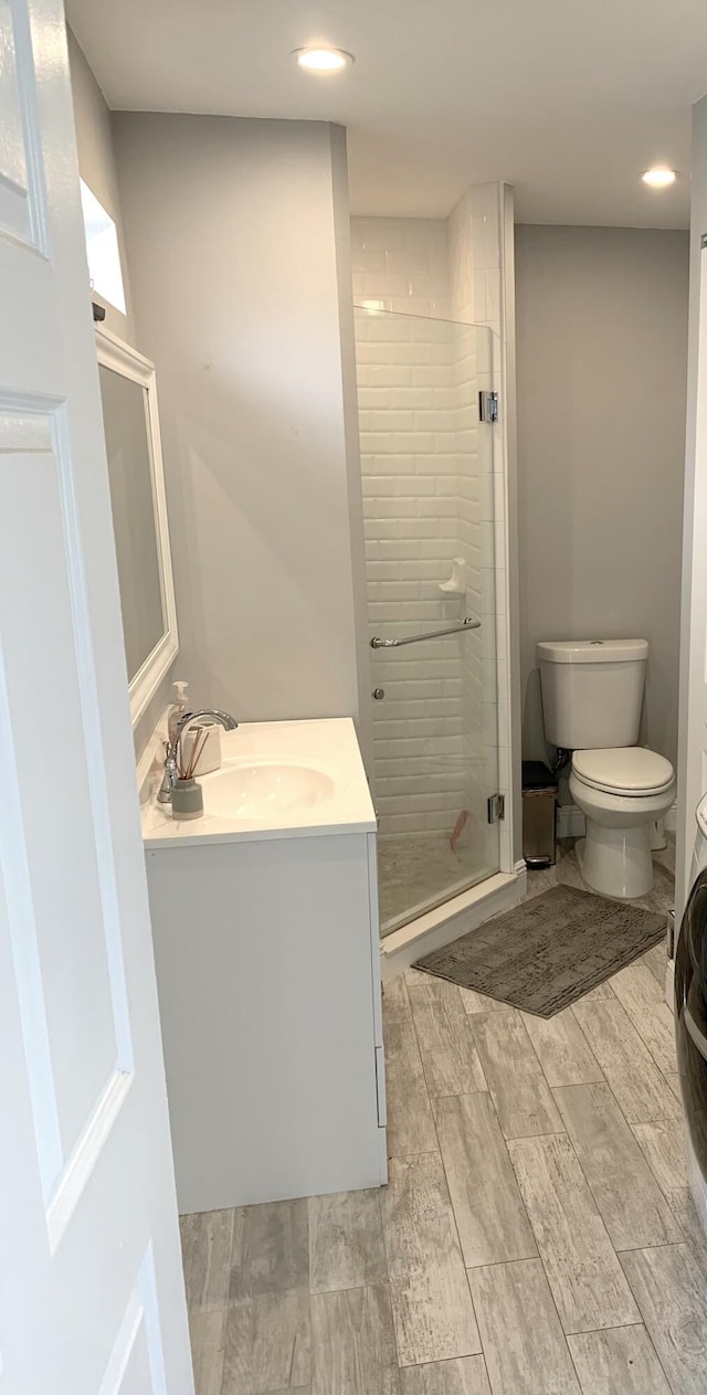 2135 NE 4th Way, Boca Raton, FL 33431 - full bathroom featuring vanity, toilet, a shower stall, wood finished floors, and recessed lighting