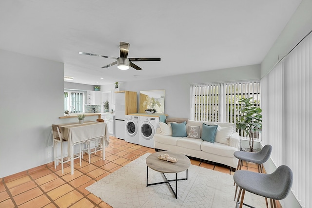 2135 NE 4th Way, Boca Raton, FL 33431 - living area featuring washing machine and dryer, a ceiling fan, and light tile patterned floors
