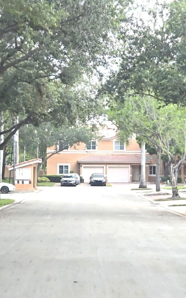2470 NW 99th Way Unit 2470, Sunrise, FL 33322 - view of front of home featuring driveway, stucco siding, and a tiled roof