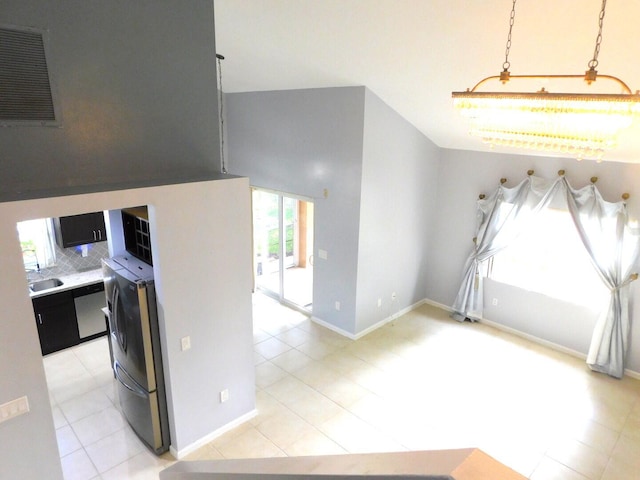 2470 NW 99th Way Unit 2470, Sunrise, FL 33322 - kitchen with light tile patterned floors, dark cabinetry, backsplash, and stainless steel dishwasher