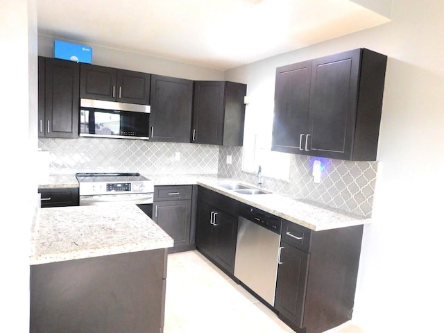 2470 NW 99th Way Unit 2470, Sunrise, FL 33322 - kitchen featuring appliances with stainless steel finishes, tasteful backsplash, and light stone countertops