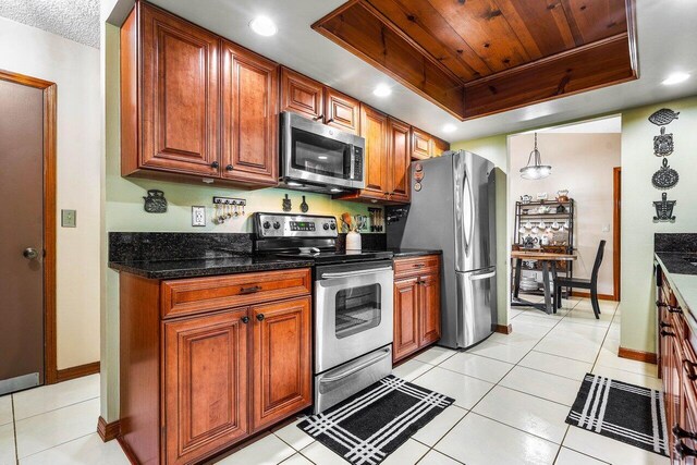 129 Parkwood Dr, Royal Palm Beach, FL 33411 - kitchen with appliances with stainless steel finishes, baseboards, light tile patterned floors, brown cabinets, and recessed lighting