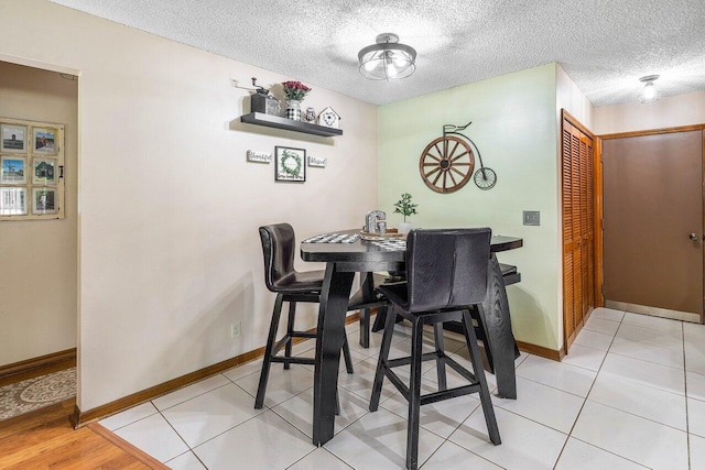 129 Parkwood Dr, Royal Palm Beach, FL 33411 - dining area with baseboards and a textured ceiling