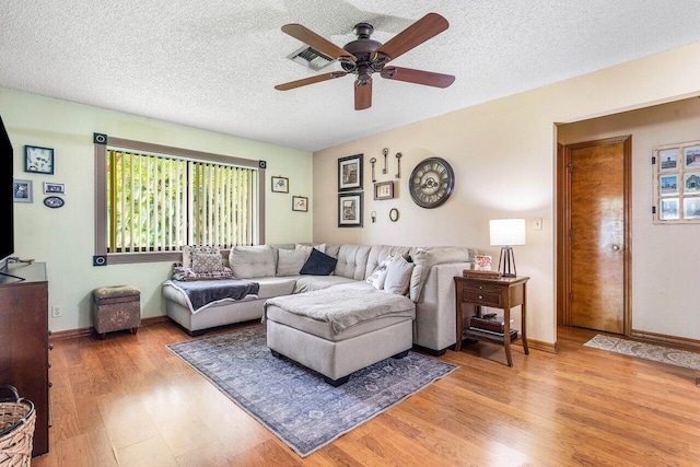 129 Parkwood Dr, Royal Palm Beach, FL 33411 - living room featuring light wood-style flooring, a ceiling fan, plenty of natural light, a textured ceiling, and baseboards